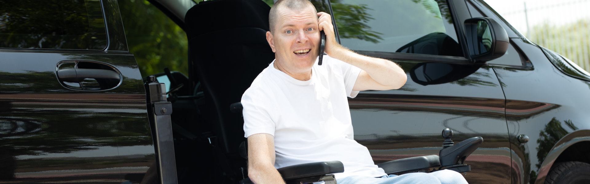 man on wheelchair using a phone