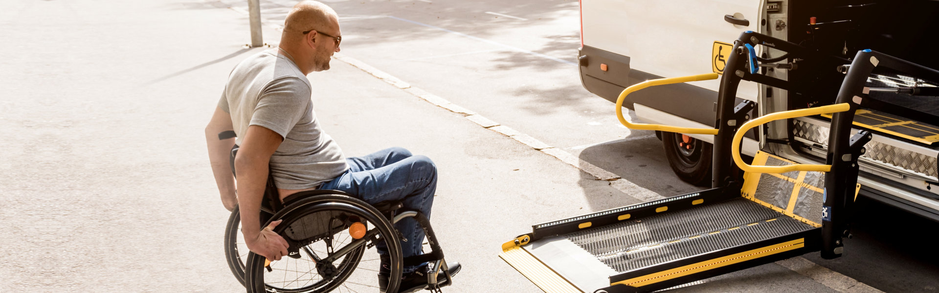 man on wheelchair getting ready to board in a van