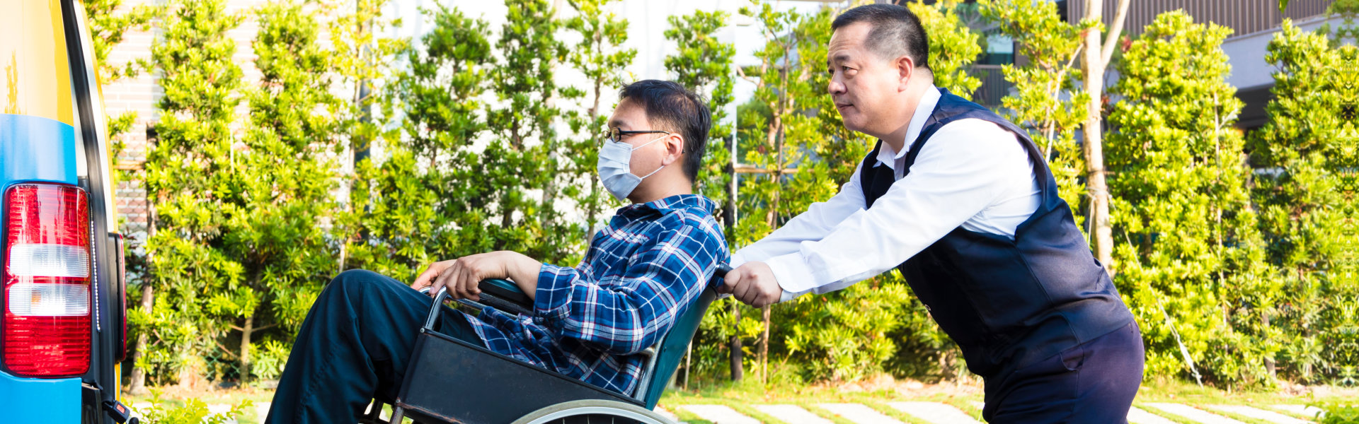 man pushing his patients wheelchair